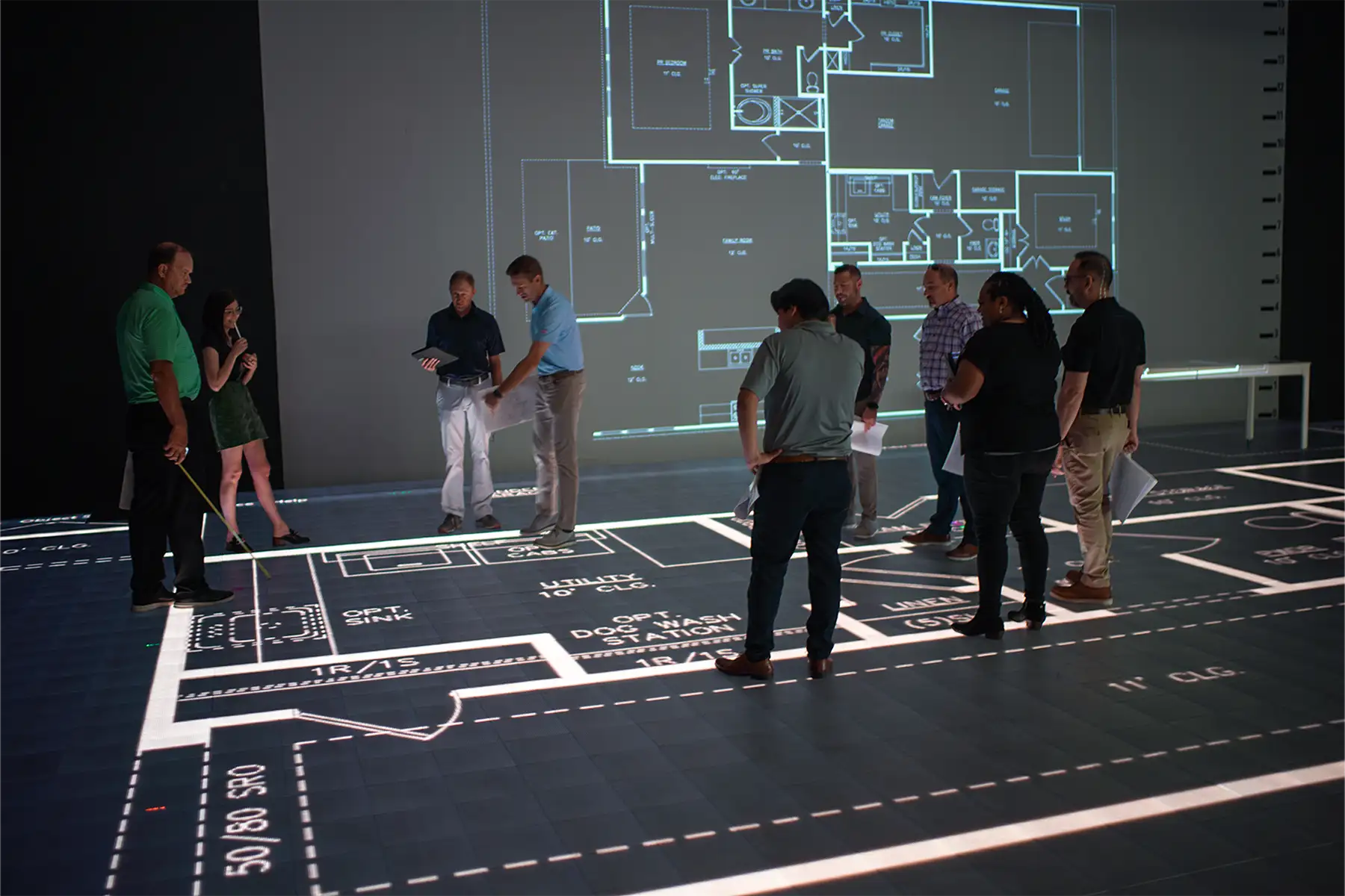 Client walking a full-size printed floor plan